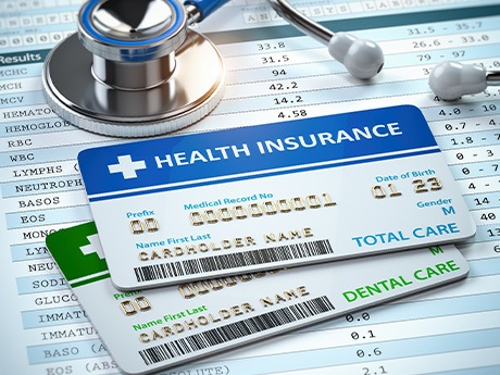 Medical insurance card lying on top of a dental insurance card