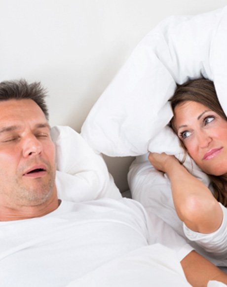 Man snoring, exhibiting signs of obstructive sleep apnea