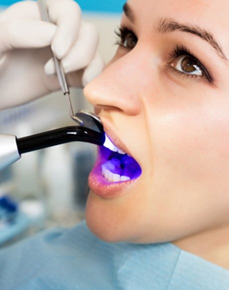 Woman at dentist receiving cosmetic dental bonding in Marysville, OH