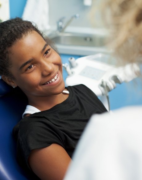 Young patient smiling during dental checkup and teeth cleaning for kids