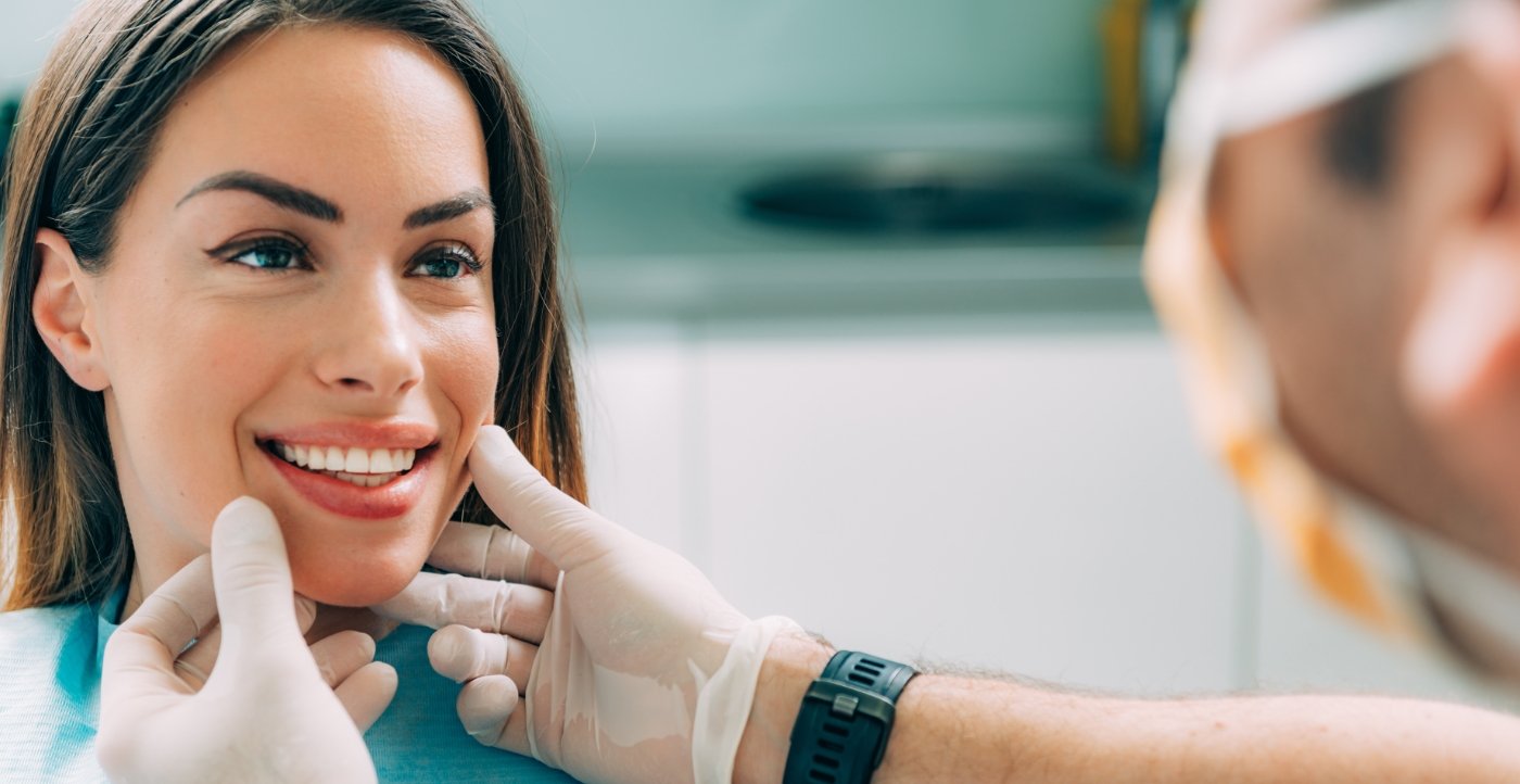 Dentist examining smile after cosmetic dentistry