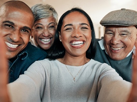 a group of mature friends smiling at the camera