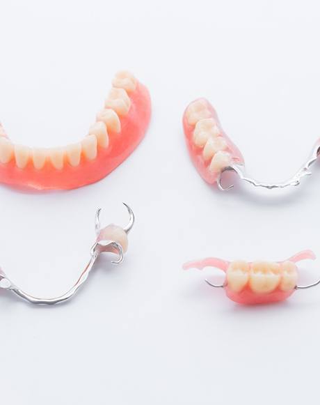 A series of dentures lying on a table