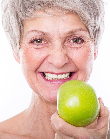 Senior holding an apple