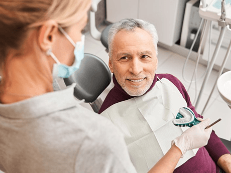 a patient talking to dentist about the cost of dentures