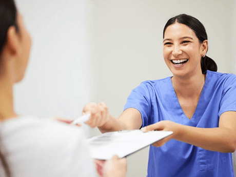 a dental staff member smiling at a patient