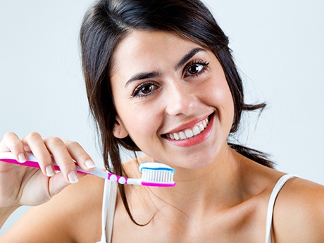 closeup of woman brushing her teeth