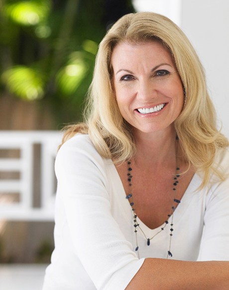 Middle-aged woman smiling after tooth removal