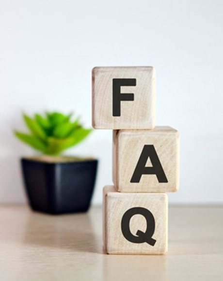 three wooden blocks spelling out F A Q
