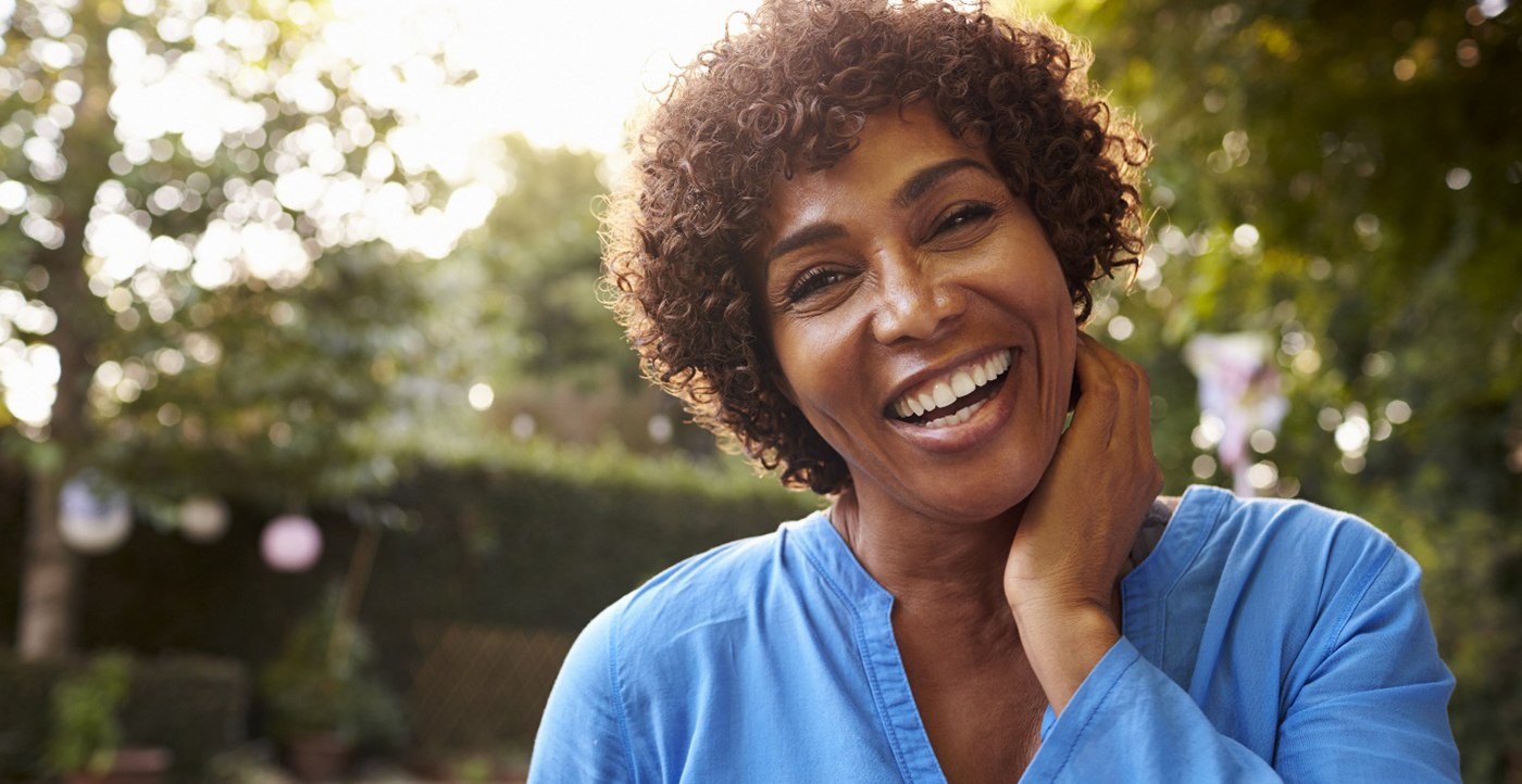 woman smiling after getting dental implants in Marysville 