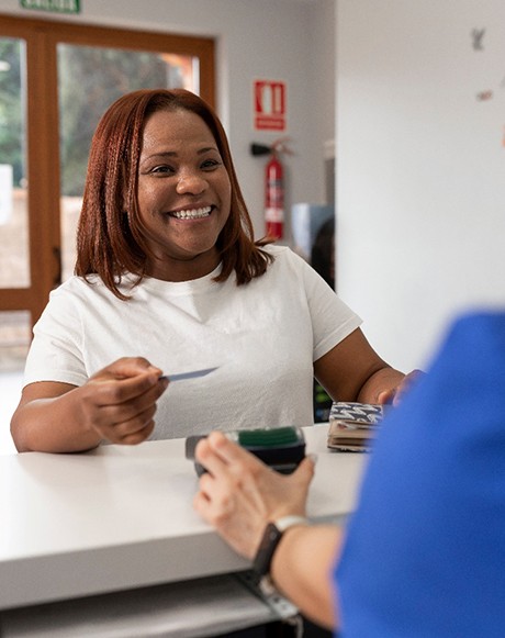 a patient paying for Invisalign treatment