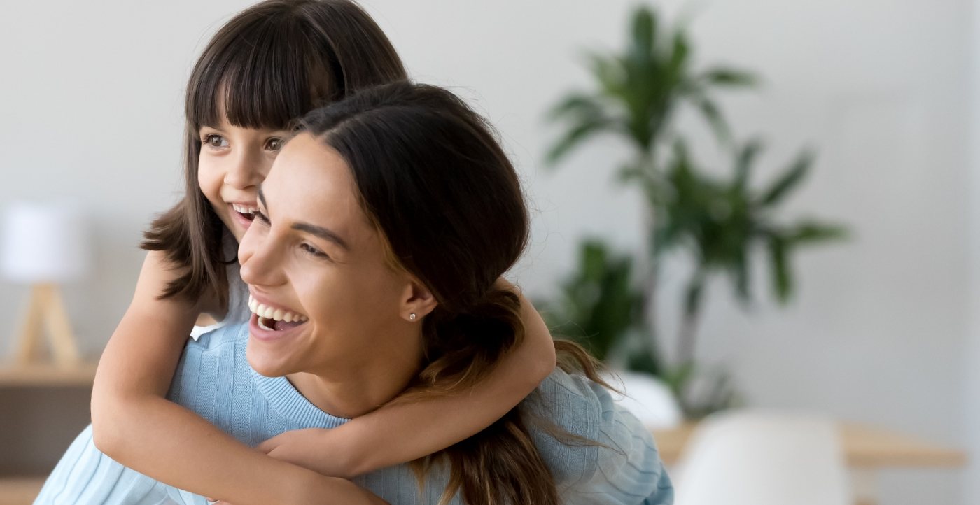 Mother and child with healthy smiles after preventive dentistry