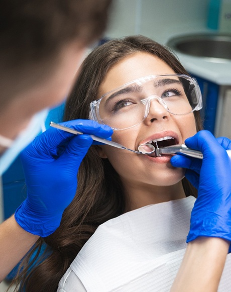 Woman in dental chair undergoing root canal procedure
