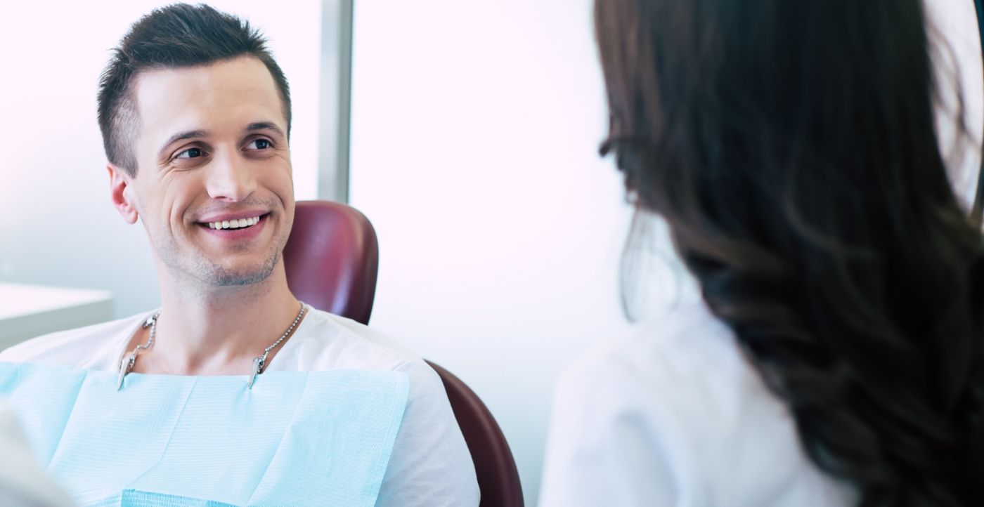 Man in modern dental office smiling