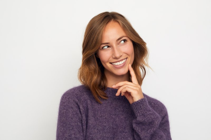 Patient smiling as they think about dental health